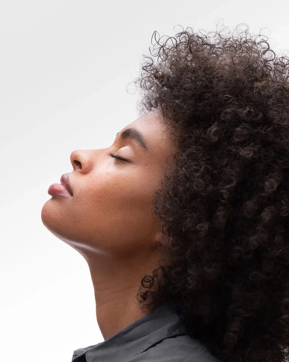 Woman with eyes closed, head tilted back, calm