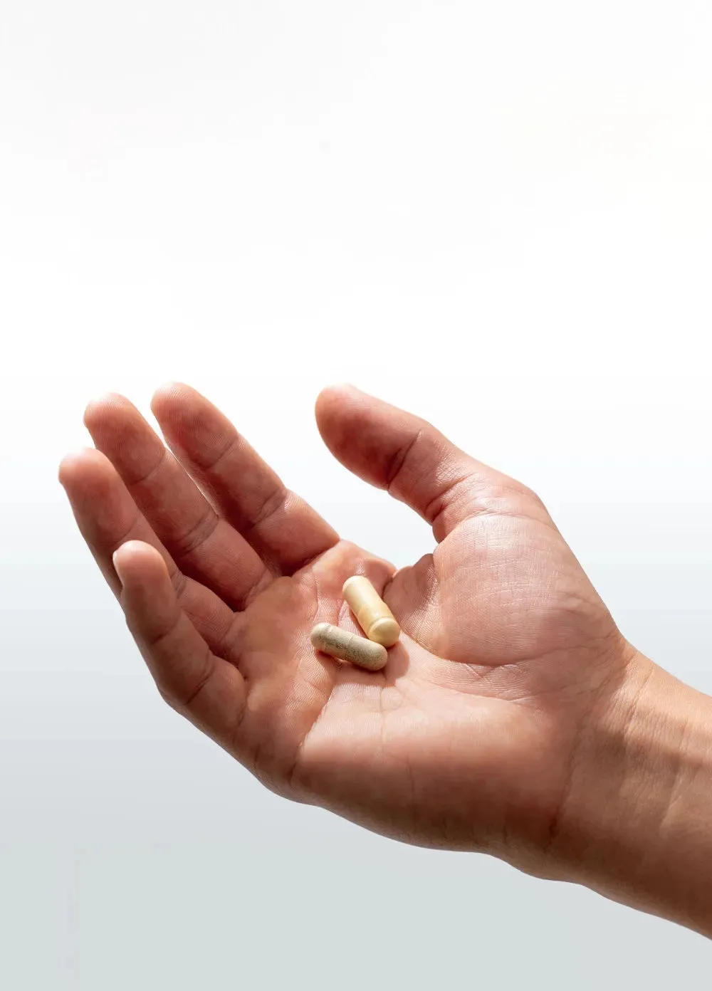 Two Stress Reset capsules in an open palm