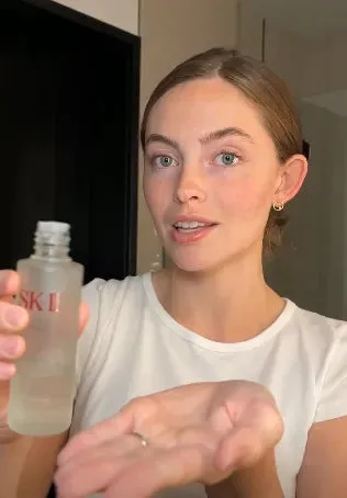 Lani holding SK-II Facial Treatment Essence above her palm