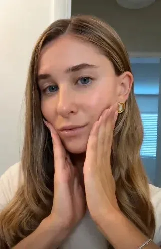 Pressing SK-II PITERA Essence into the cheeks