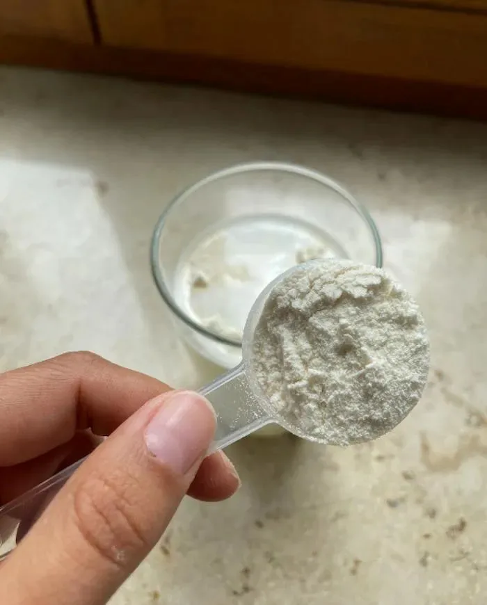 A scoop of Primal Collagen over a white drink