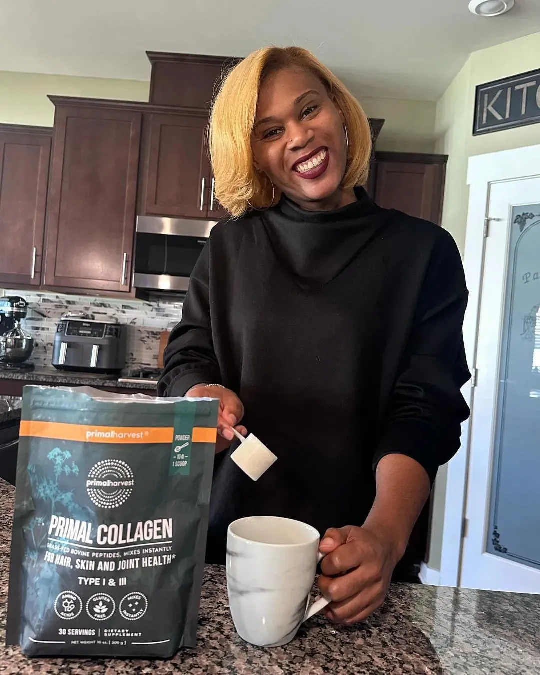 Woman with Primal Collagen and a mug
