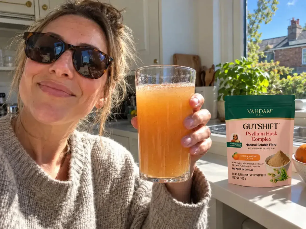 A GutShift orange drink in a sunny kitchen