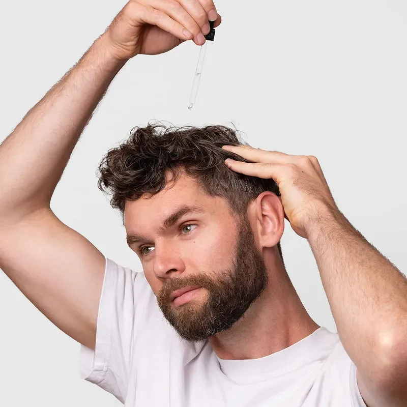 Applying Bio-Pilixin serum directly to the scalp with the dropper