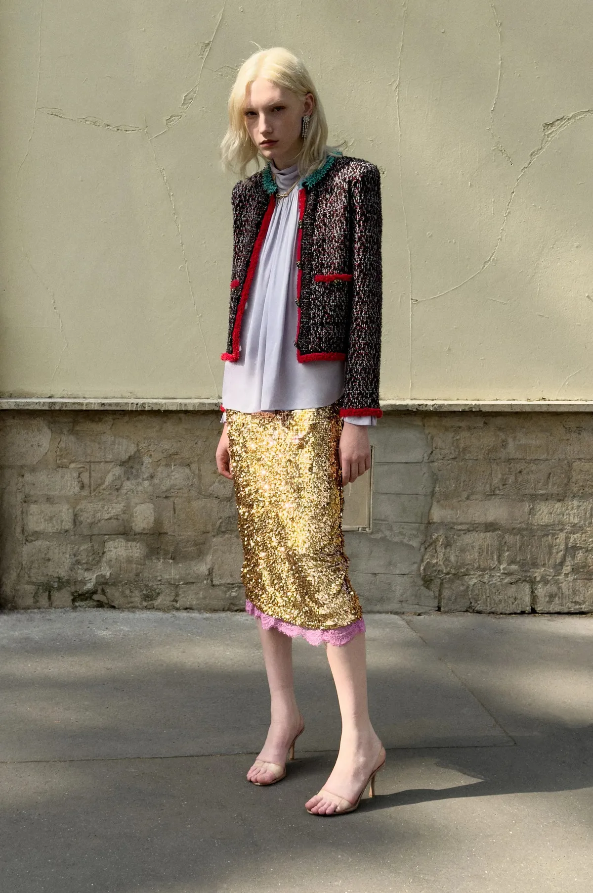 Resort 2027 textured knitwear and a gold sequin skirt photographed outdoors