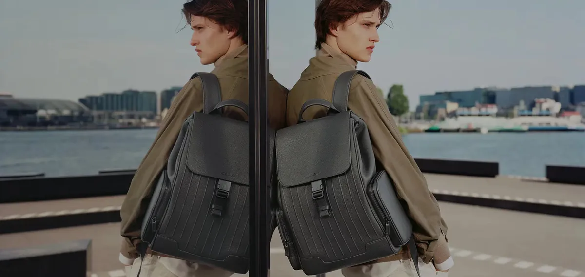 A new perspective: the Never Still Flap Backpack reflected in glass