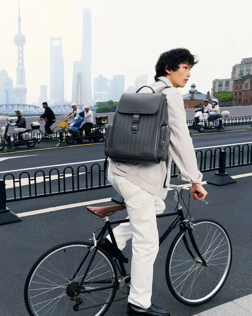 The Never Still Flap Backpack, worn with understated city tailoring