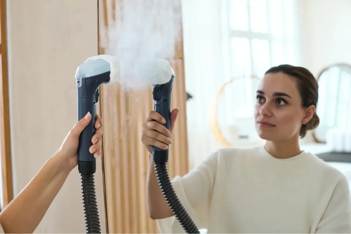 Using the PowerClean Pro steam attachment to clean a bathroom mirror