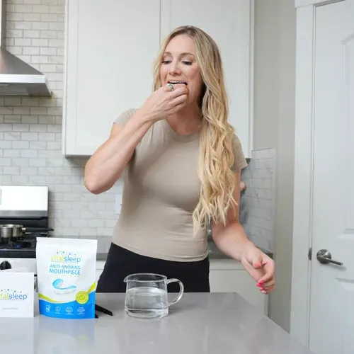 Woman fitting a VitalSleep mouthpiece