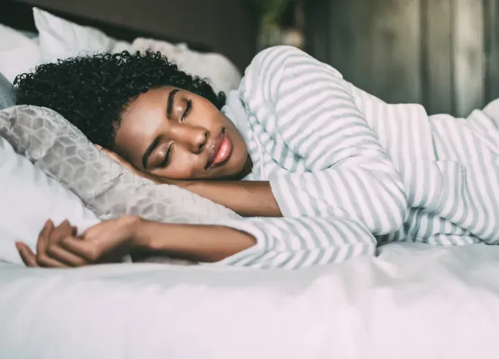 Woman resting peacefully in bed
