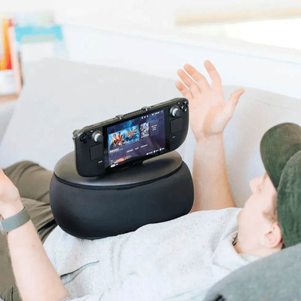 Gaming Pillow supporting a Steam Deck while a gamer relaxes on the couch