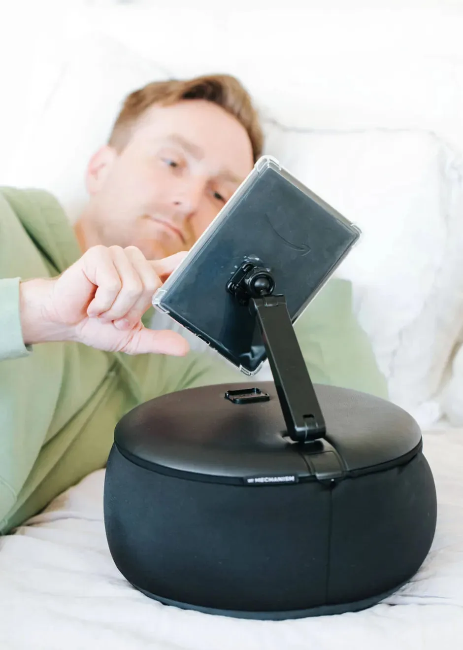 An e-reader supported by the Gaming Pillow with a compatible grip